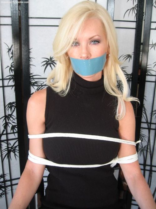 kidnappingcouple:  She squirmed more than I had expected her to, but I had her tied to the chair soon enough. The tape over her mouth ended her protesting, but she kept trying to talk to me. That was fine. “I love it when you mumble for me,”