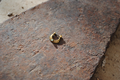 Custom piece w/niobium hinge, gold ceramic plate, and white opal. by Honeycomb Organics
