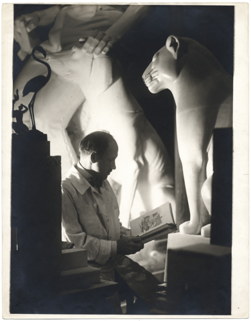 Paul Manship seated among his sculptures reading a book circa 1939Photographer. Alfredo Valente Arch