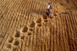  Hanna Sorhus was on her way to Laos when she caught these two on their way home. The woman is carrying her baby up steep vertical steps. (Source) 