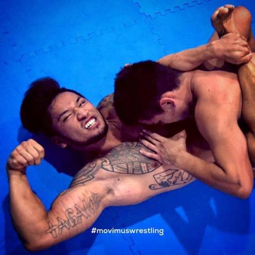 movimuswrestling: Shawn Duncan flexes his biceps while Evan Turner is caught in a tight leg scissors