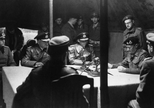 Field MarshalBernard Montgomery [right] reads over the surrender pact, whilesenior German officers l