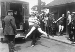 blondebrainpower: July 12, 1922 In Chicago, Illinois, a woman is being arrested for defying a Chicago edict banning “abbreviated bathing suits” on beaches. Image: Bettmann/CORBIS 