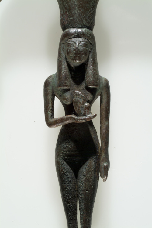 egypt-museum:Mirror: Isis with Horus as a babyThis bronze mirror portrays Isis as a figure of fertil