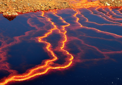 nubbsgalore:  a river runs through it. and by it, i mean a five thousand year old copper, silver and gold mine in huelva, spain that renders the tinto river alien and lava like in appearance, a result of the oxidation of iron and sulfur minerals by the