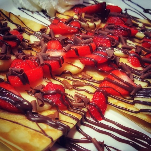 Hot waffle with chocolate and strawberries.