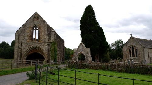 The Gatehouse of Easby Abbey with the Parish Church of Saint Agatha, North Yorkshire, England.Need t