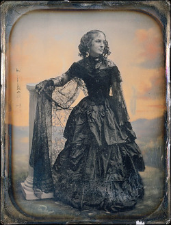 thecivilwarparlor:  Woman in Black Taffeta Dress and Lace Shawl-Pre-Civil War  Women’s dress in to the Civil War, Women loved the idea of a tiny waist with yards of material in the skirt. The corset was being worn along with a metal hoop and crinoline