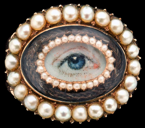 ufansius:Gold memento mori ring set with a miniature painting of an eye, surrounded by seed pearls a