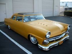 groundclearance:  &lsquo;55 Ford custom. Chopped top with the Sun Valley glass insert, '55 Olds headlight bezels, portholes added to the hood, rolling on chrome reverse and skinny whites. An all around tasty mf car.  