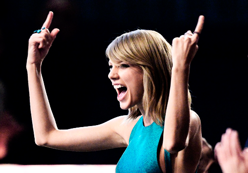 : Taylor Swift cheers from the audience at the 2015 Grammy Awards