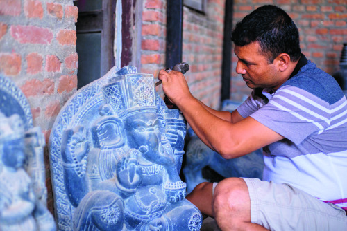 Artist Chandra Shyam Dangol working in a Ganesha sculpture, Nepal