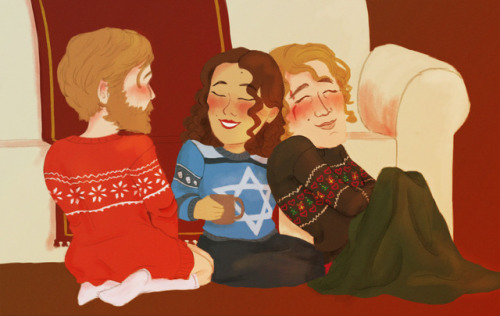 some holiday sweaters by the fireplace 