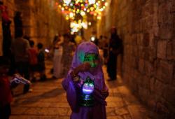 iseo58:A young Palestinian girl walks in an alley of Jerusalem’s old city holding a traditional lantern while celebrating with other children the announcing of the holy month of Ramadan. 