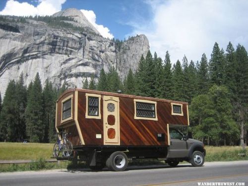 magicalandsomeweirdhometours:This house truck was handbuilt with meticulous craftsmanship.The entrance door has a lovely, round stained glass window, and look at the sweet little stove w/a brass protective wall.The wood is just beautiful- look at the