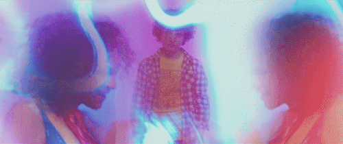 Young Danny (played by Finn Wolfhard) looks dejected between mirror images of present Danny's singing head. The images fade to show present Danny singing to his younger self, both seen from the side.

