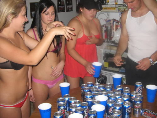 A fun strip flip cup game - the girls are already down to bras and thongs at the start of the photos