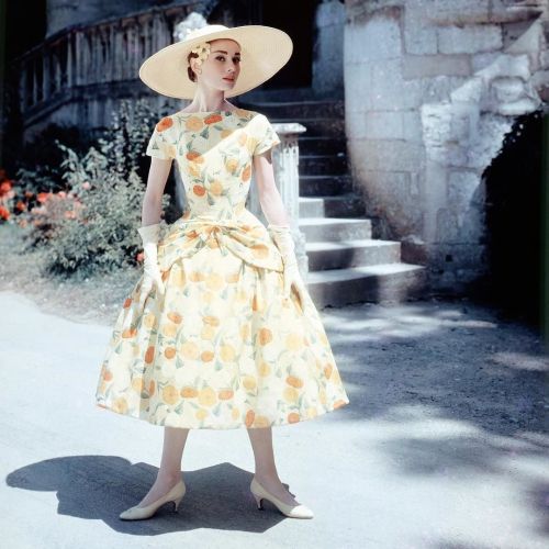 Audrey Hepburn in a floral-print day dress and sun hat, circa 1955. #oldschoolcool #audreyhepburn #b