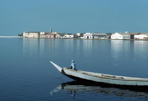 The Island of Saint-Louis, oceanic port of West Africa, is a miniscule strip of land, today wedged b