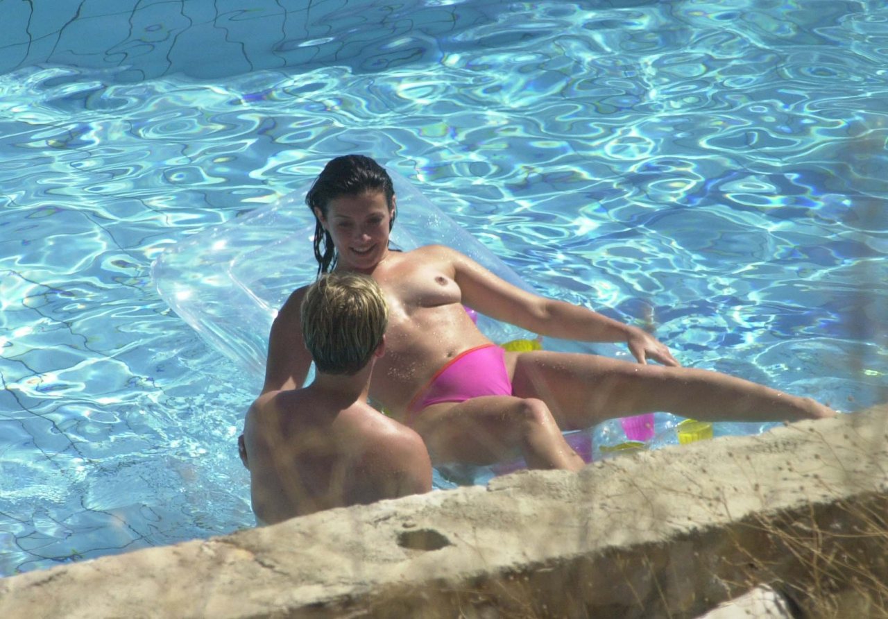 toplessbeachcelebs:Kym Marsh (British Model) swimming topless in a pool (August
