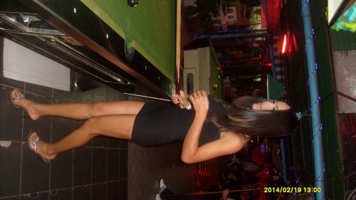 femboy in minidress and high heels playing pool