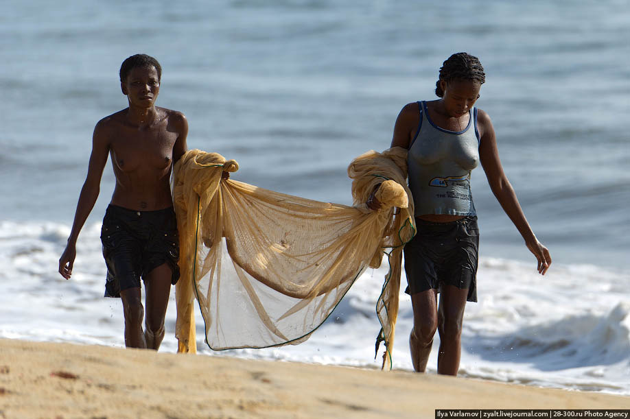 Topless Madagascan girl fishing.