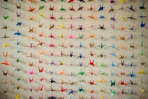 1000 colourful paper cranes were created which adorned the walls, tables, and backdrops for the cere