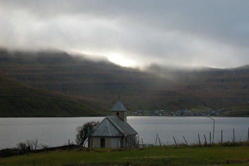 Church of Selatrað (Faroe Islands).  The village of Hósvík on theisland of Streymoy can be seen acro