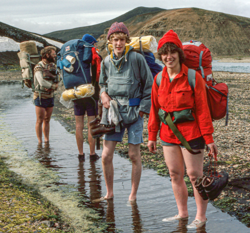 Some Hikers Warm Up Their Feet In A Slow Flowing Hot Stream After Crossing An Icy River.