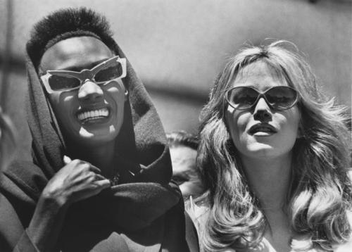 Grace Jones and Tanya Roberts photographed on location in Paris, taking a break during the filming o