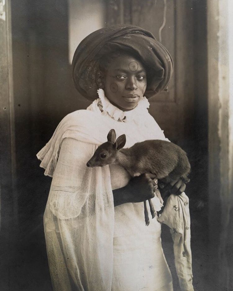 harrowingp:  A young Kenyan woman holds her pet deer in Mombassa, March 1909.Photograph