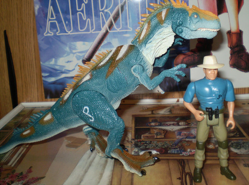 I thought I’d do something a little differently and discuss a new Jurassic Park action figure– The newer Allosaurus from the “Dino Showdown” line, available at Toys R’ Us:   Here I’ve used my figure, and the figure