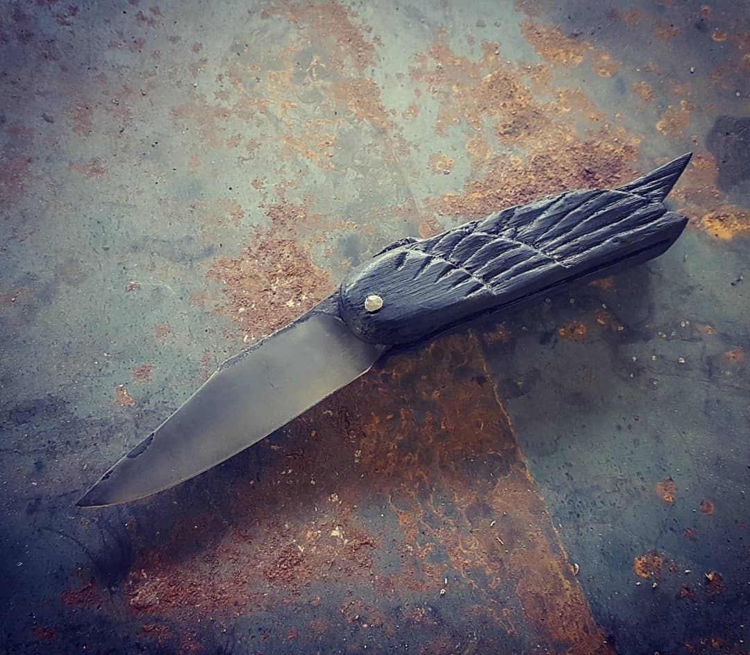 fab-bladesmith:  Raven FolderHigh Carbon steel blade, hand-carved ebonized oak handle.