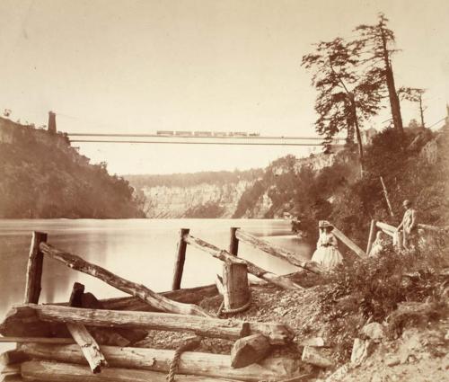 Picnicing by the Niagara Railroad Bridge, Niagara Falls, New York.Built by engineer John Roebling of