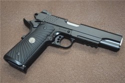 gunrunnerhell:  Wilson Combat X-TACHigh end 1911 that gets it’s name from the “X” shaped serrations on the slide and the texture along the front and back strap of the grip. The one in the photos is chambered in 9x19mm but the X-TAC is also available