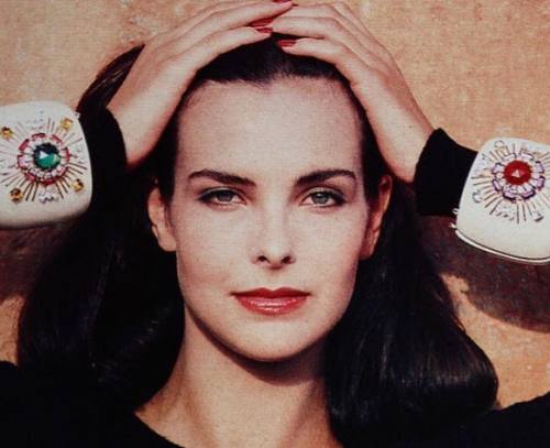 Carole Bouquet is wearing Maltese cross bracelets decorated with gemstones by Verdura for Chanel Fra