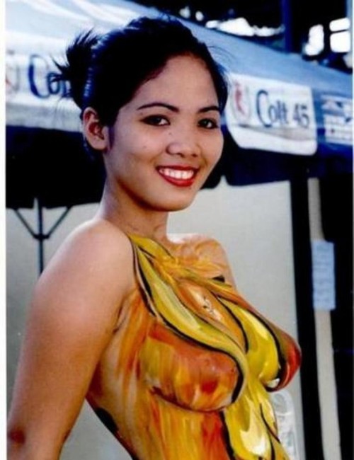 asianaturals:Breasts with paint and smile. Welcome to the Philippines. That paint on her skin makes 