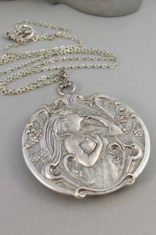 sixpenceee:This antique silver locket has a beautiful woodland goddess smelling her woodland flowers