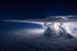 sixpenceee:  Thunderstorm photographed over the Pacific Ocean at night. The photographer and pilot, Santiago Borja, says he was circling around it at 37,000 feet altitude en route to South America when he captured this spectacular view. 