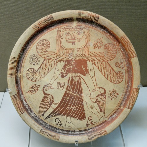 A plate depicting a winged, Gorgon-headed deity, shown in the traditional pose of the Πότνια Θηρῶν (