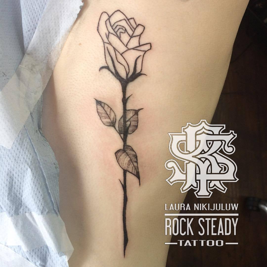 Single needle rose tattoo on the rib