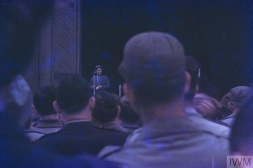 Bing Crosby performs for USAAF personnel in front of a hangar at RAFDuxford, home to the 78th Fighte