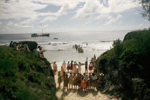 The arrival of a supply boat draws a crowd to the beach on Mauke Island in New Zealand, 1967.Photogr