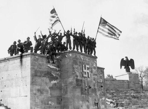 historicaltimes:American soldiers from the 45th infantry division celebrate atop the Luitpold Arena 