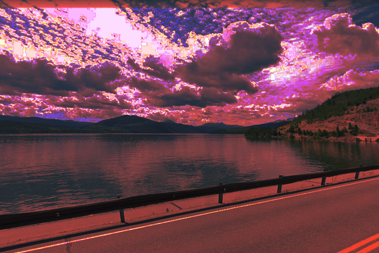 A dammed lake sits framed by a road in the foreground; mountains in the background. The sky above appears pink and bitcrushed.