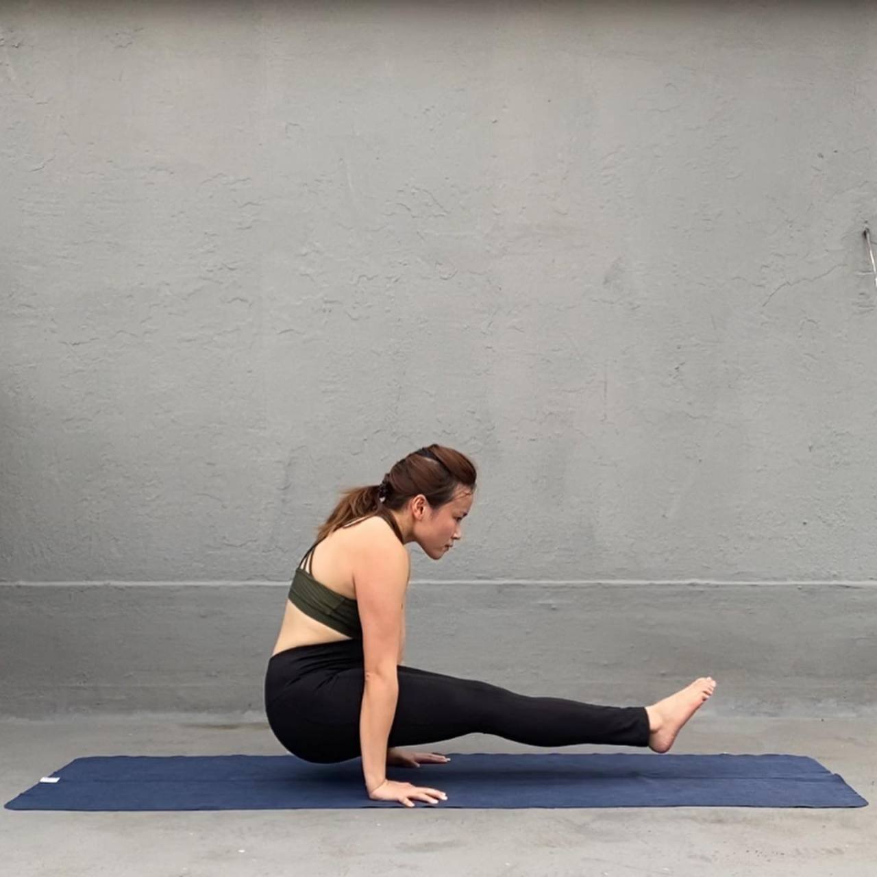 Woman practicing yoga doing Eka Bhuja Svastikasana exercise, asana for  shoulder joint, exercising in studio in sportswear Stock Photo - Alamy