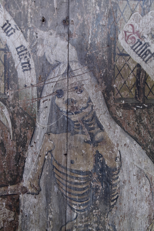 The remainder of a Rood Screen (circa 14th C)  shows the dance of death with the Latin inscriptions: