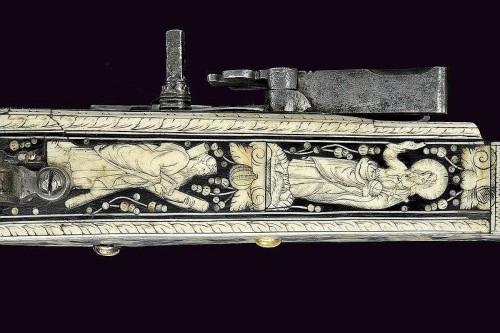 A beautiful 17th century wheel-lock rifle decorated with bone, silver, and gold.  Most likely G