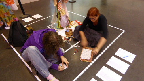 <p>Closing reception of the Feminist Art Conference <a href="https://www.facebook.com/FeministArtConferenceTO">FAC</a> exhibition. I love this image of the sewers inside the intimate sacred space of the labyrinth. I was fortunate to have two long time artist friends; poet <a href="http://evatihanyi.com/">Eva Tihany</a> and visual artist Shannon MacKinnon come to the exhibition. Once the conversation around the Dream Scroll began women began to engage with the Dream Scroll, writing and sewing their dreams into it. I brought the Dream Scroll home with me to Carbondale and next week will have a performative sewing event to Tend the Dream Scroll and prepare it for its next installation in Alexandria, Egypt in March 2016. <br/></p>