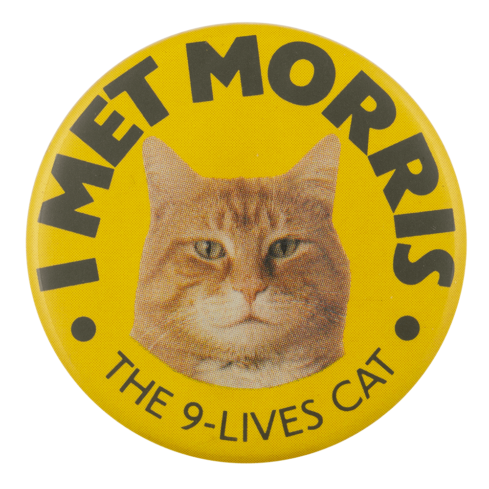a yellow pin with black text reading 'I MET MORRIS THE 9-LIVES CAT'. and an image of an orange cat in the center